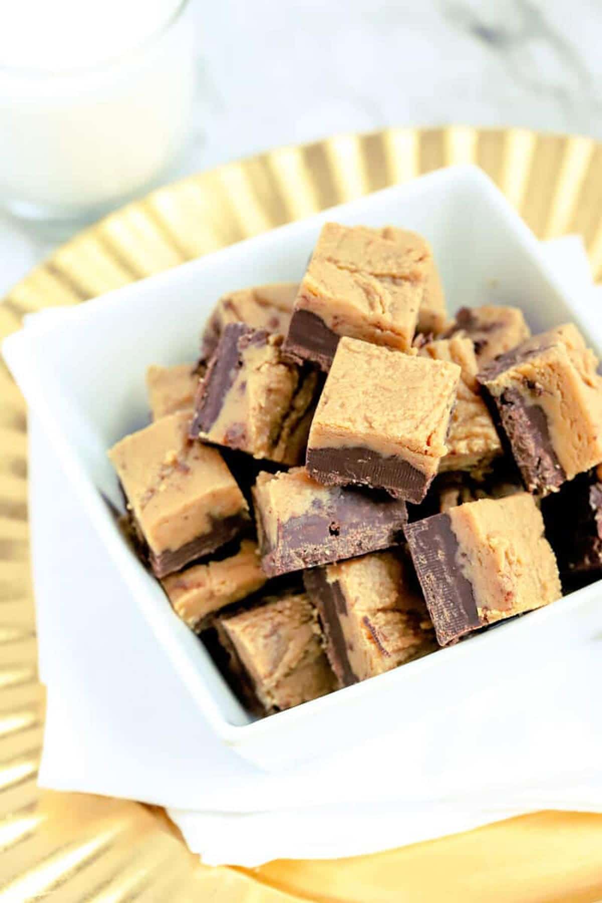 https://recipesworthrepeating.com/wp-content/uploads/2021/06/1-chocolate-peanut-butter-fudge-in-white-square-bowl-on-gold-tray.jpg
