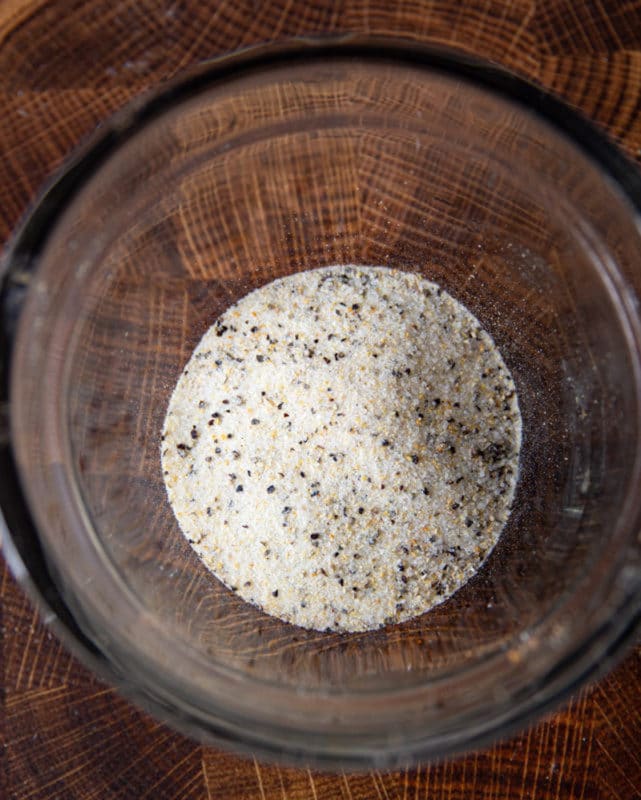 Bowl containing salt, pepper, and garlic powder.