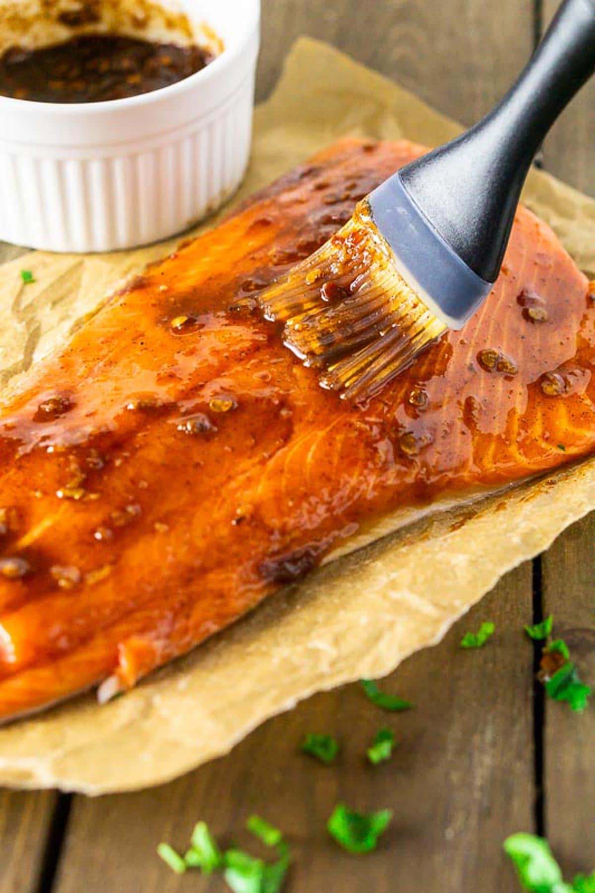 Brushing on the Maple Chipotle marinade onto a filet of Salmon.