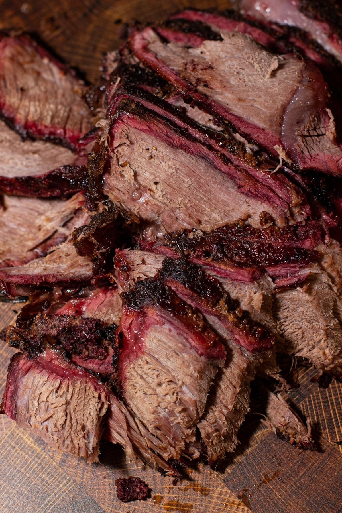 Smoked Chuck Roast sliced on a cutting board.