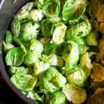 Brussels sprouts being blanched in a boiling pot of water.