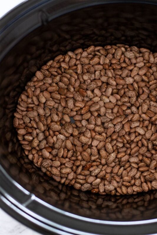 Pinto beans in a slow cooker.