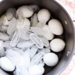 12 boiled eggs in an ice bath.