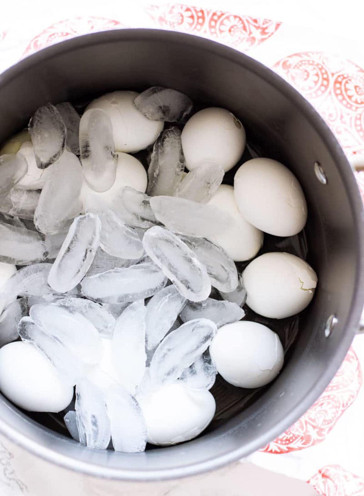 12 boiled eggs in an ice bath.