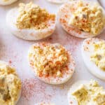 Close up of filled deviled eggs topped with Paprika.