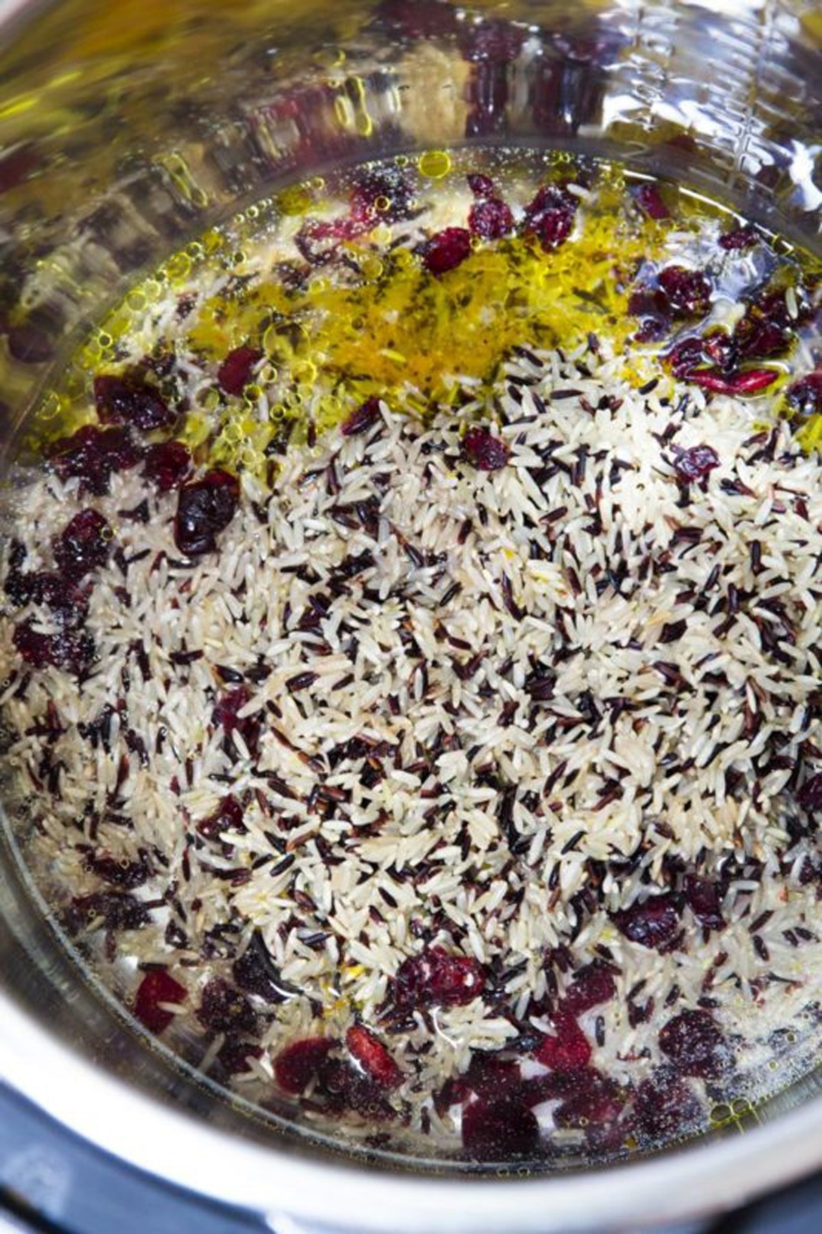 rice, water, lemon juice, olive oil, and dried cranberries in an instant pot.