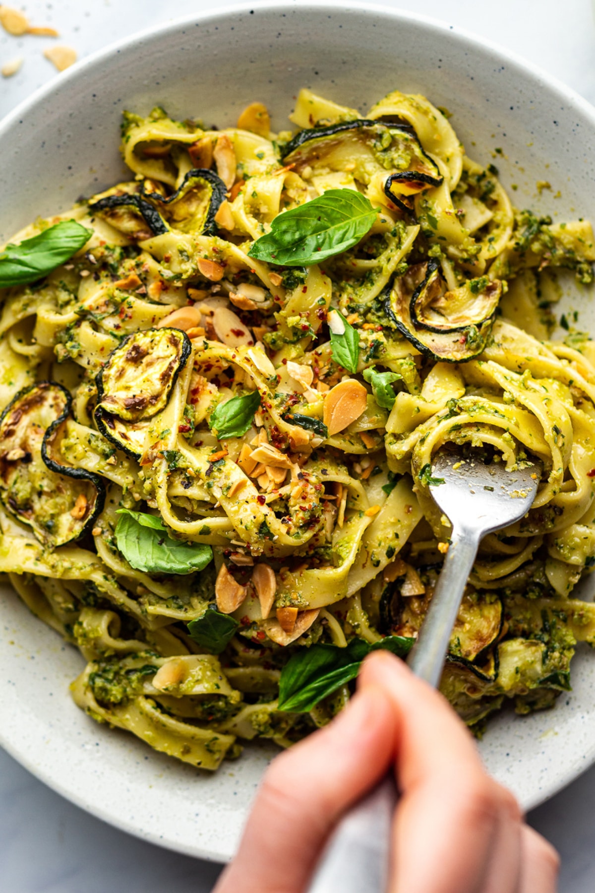 Person spinning a fork in a zucchini pasta. 