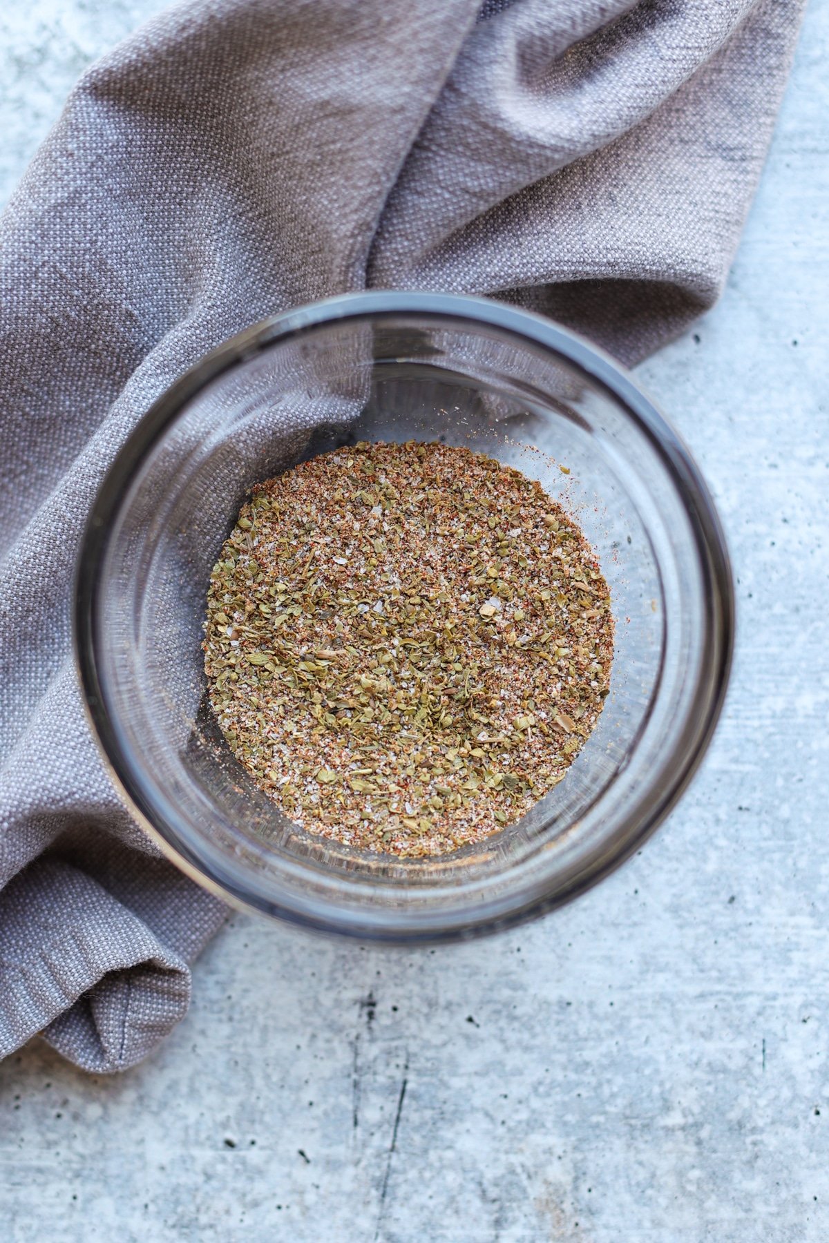 Glass bowl containing chicken spice rub.