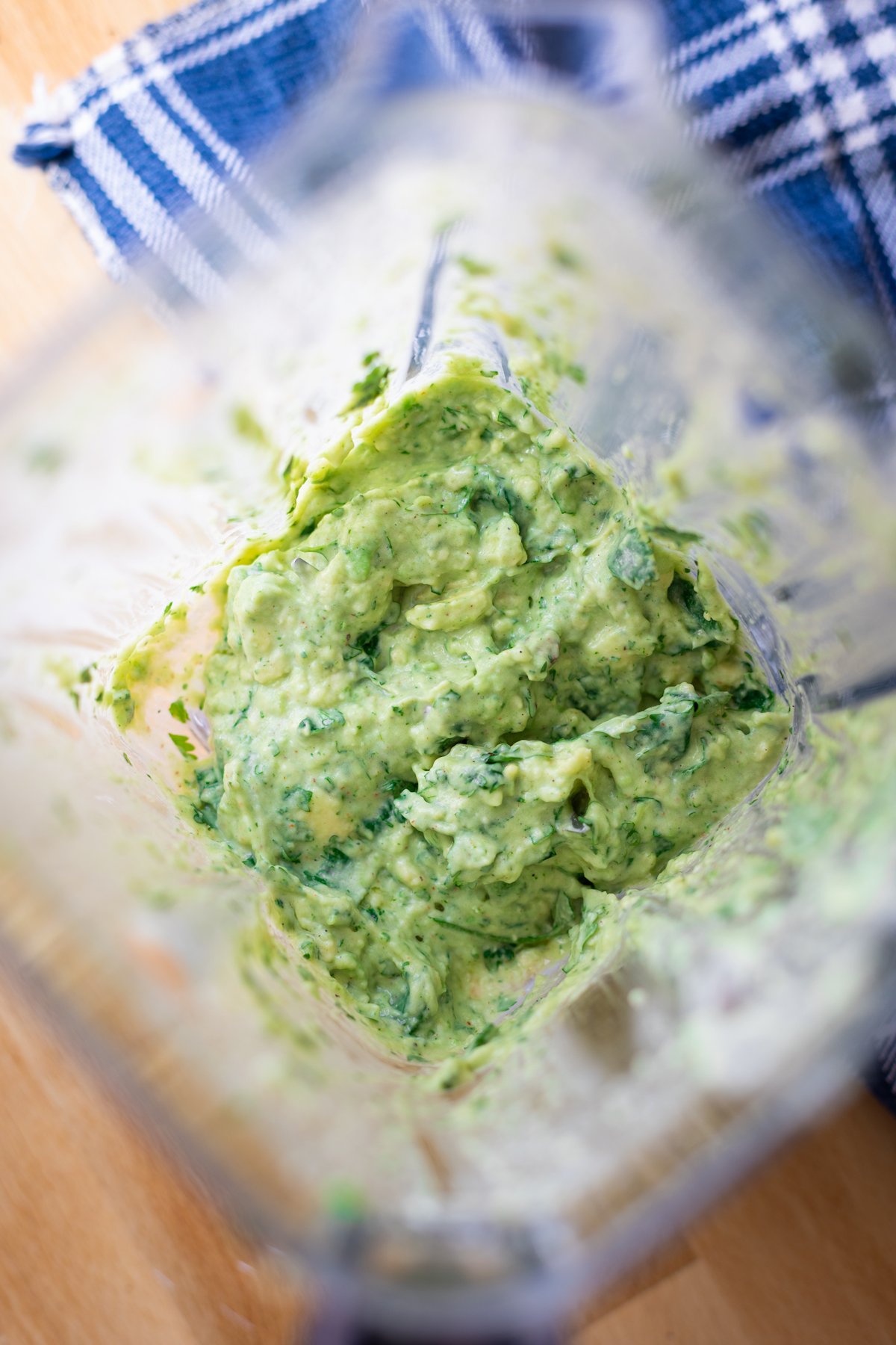 Food processor filled with a creamy avocado sauce. 