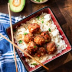 Dish containing turkey meatballs served over white rice.