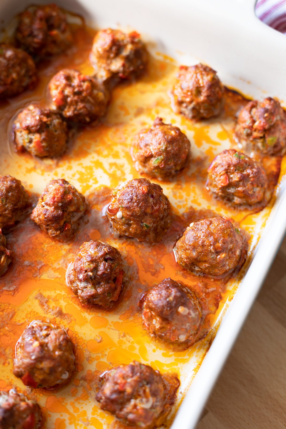 Baked meatballs in a baking dish. 