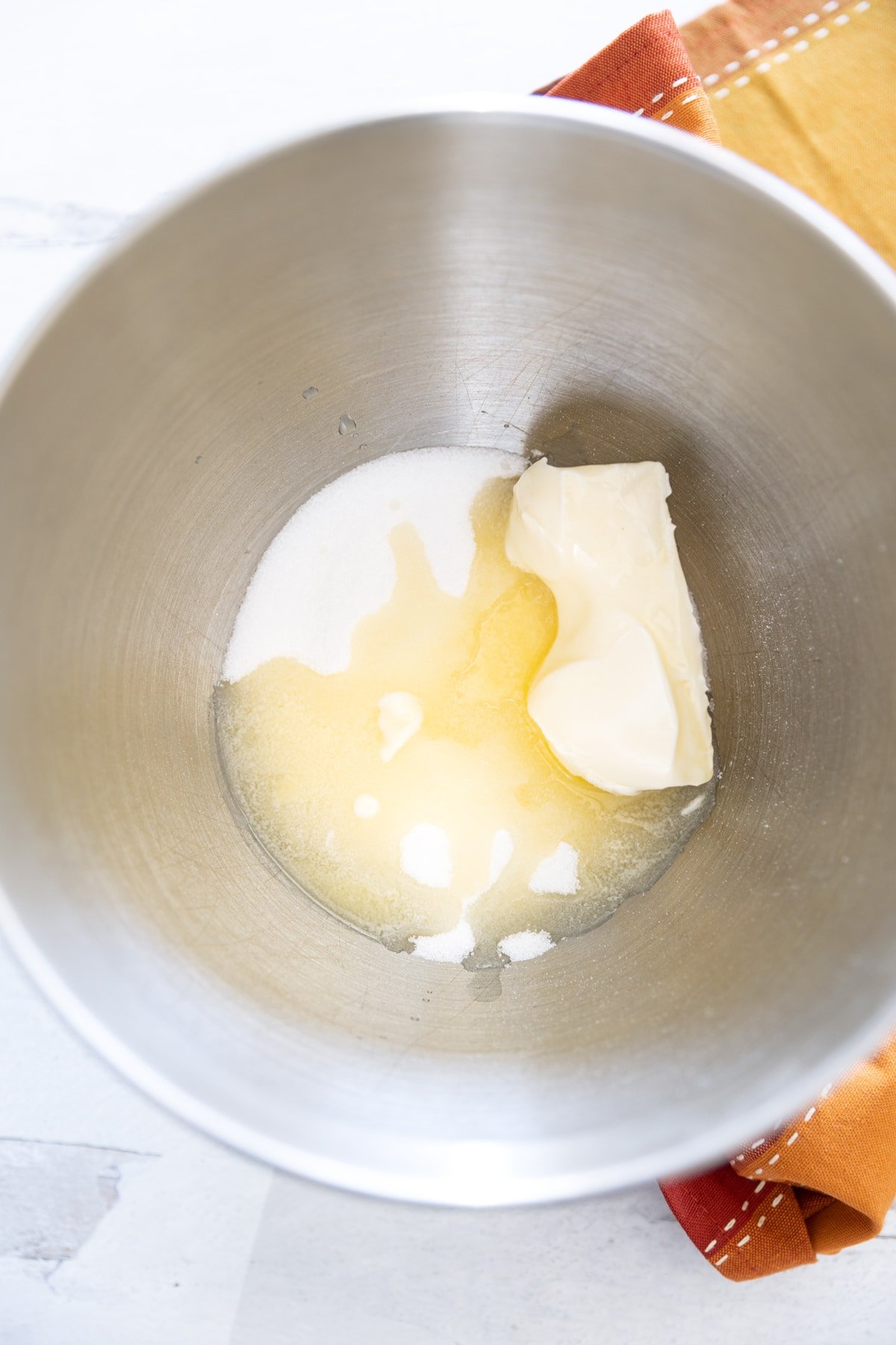 mixing bowl containing sugar an butter. 