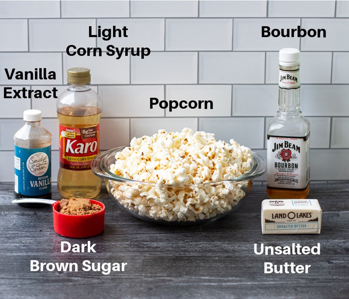 Ingredients on a counter for making caramel popcorn, including bourbon.