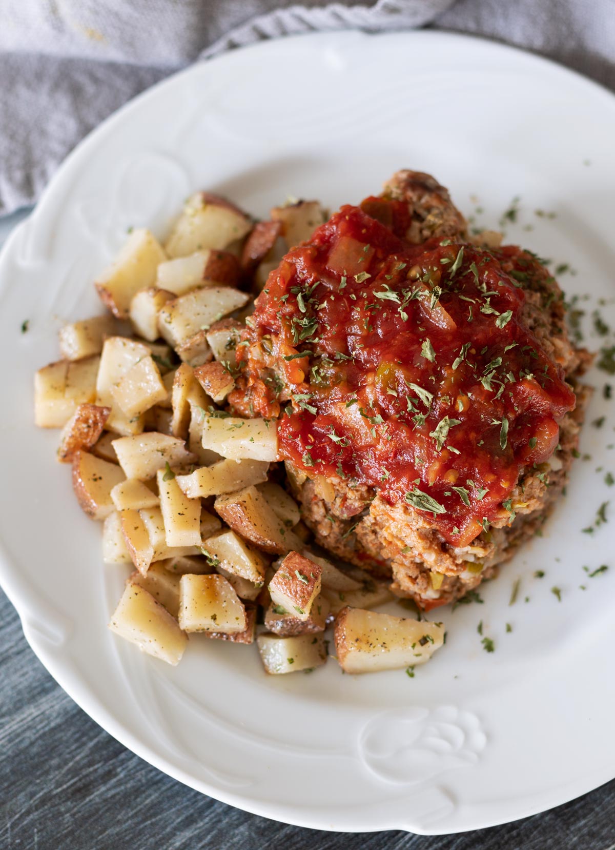 Cooked turkey meatloaf served with a side of potatoes. 