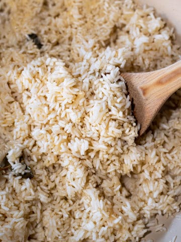 Closeup of rice pilaf with wooden spoon.