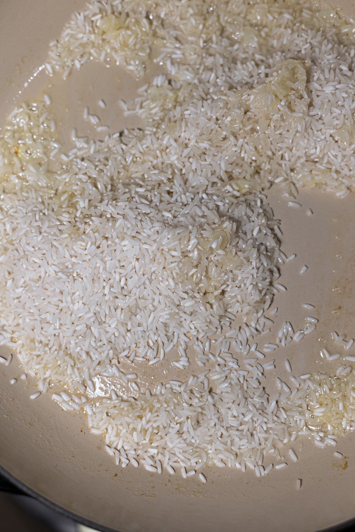 Pearling rice in a skillet with melted butter and sauteed onion. 