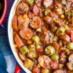Okra and sausage stew in a skillet.