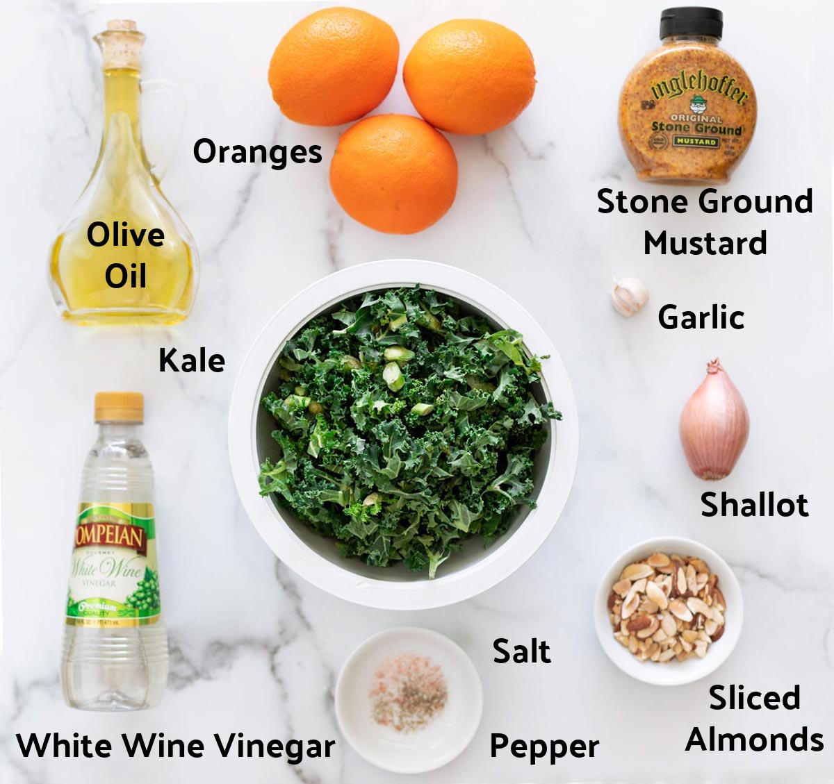 Ingredients to make a kale salad and vinaigrette dressing on a counter.