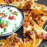 Keto nachos topped with bacon and scallions served with ranch dip.