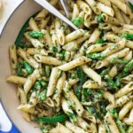 Large blue pot with pesto pasta with aparagus
