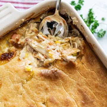 Chicken pot pie casserole with spoon scooping out a serving