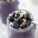 Blueberry oatmeal smoothie topped with blueberries and oatmeal seeds.