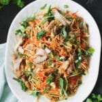 Plate filled with zoodles topped with chicken.