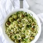 Skillet filled with zucchini noodles with turkey meatballs.