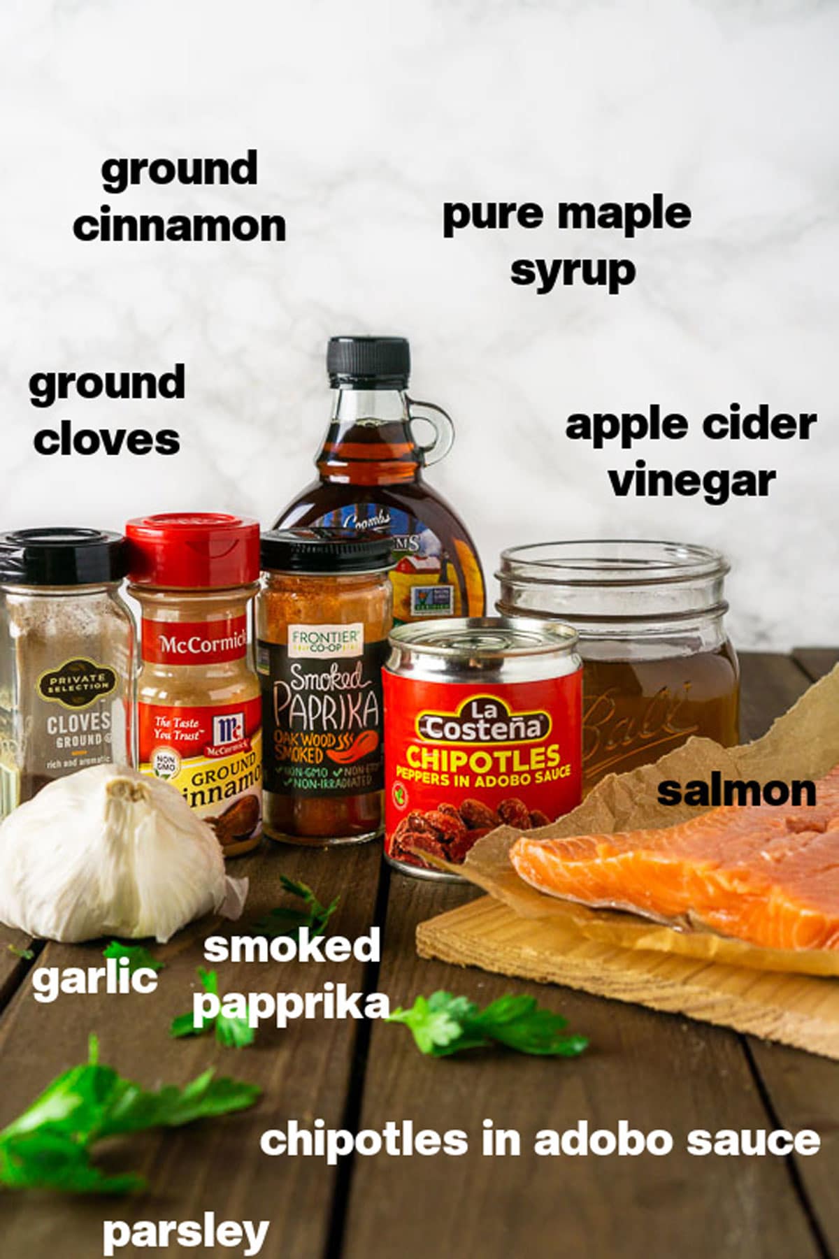 Ingredients to make Maple Chipotle Grilled Salmon sitting on a wooden table.