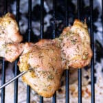 Chicken thigh with temperature probe on a smoker