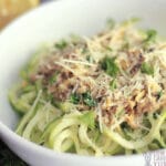 Close up of spiralized zucchini topped with a creamy white clam sause.