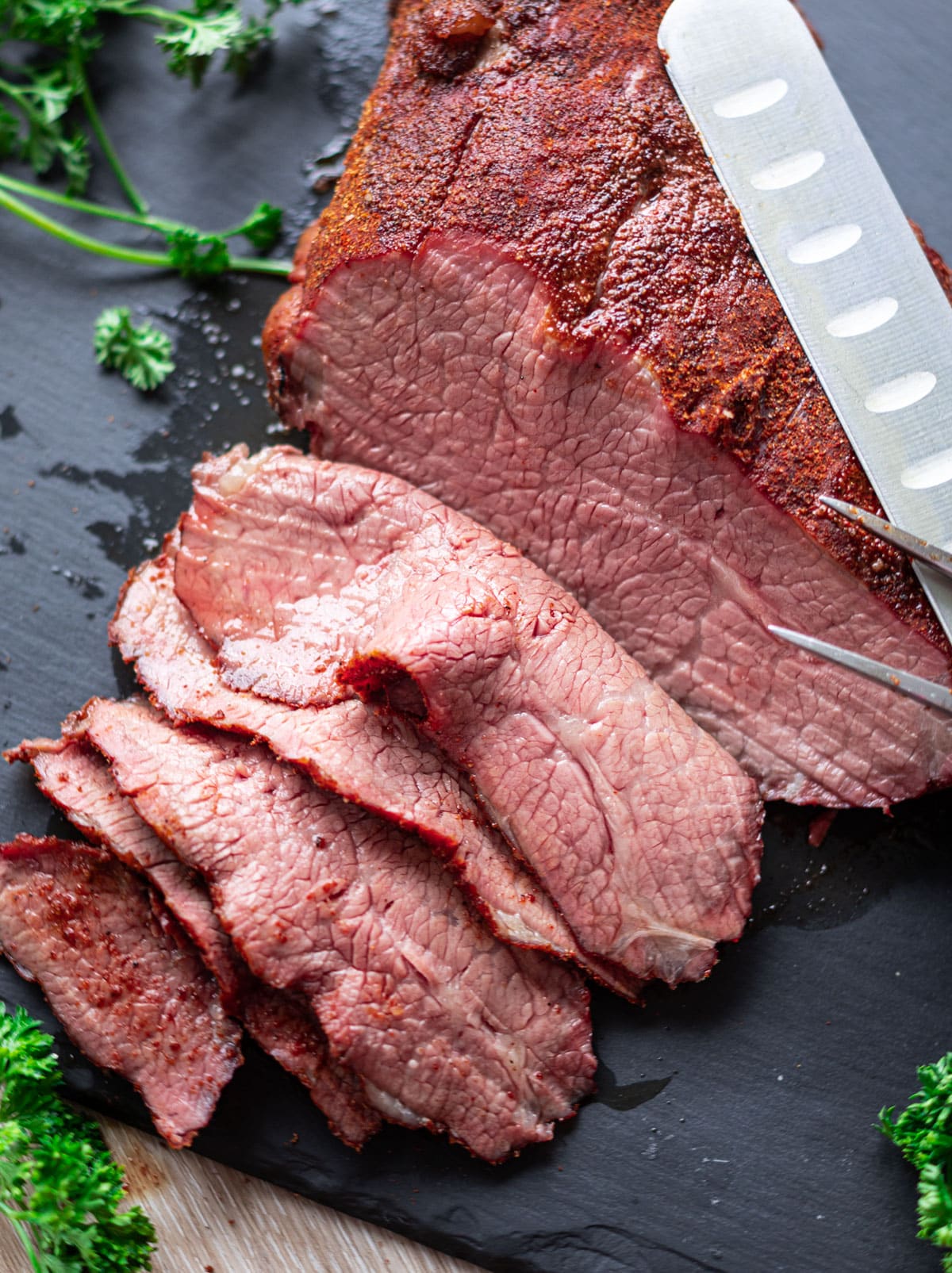 Close up of person slicing a smoked tri tip.