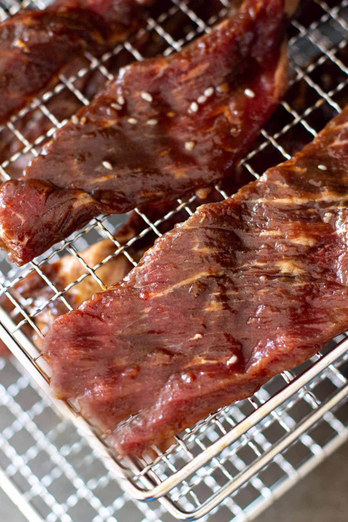Close up of beef jerky on a dehydrator. 