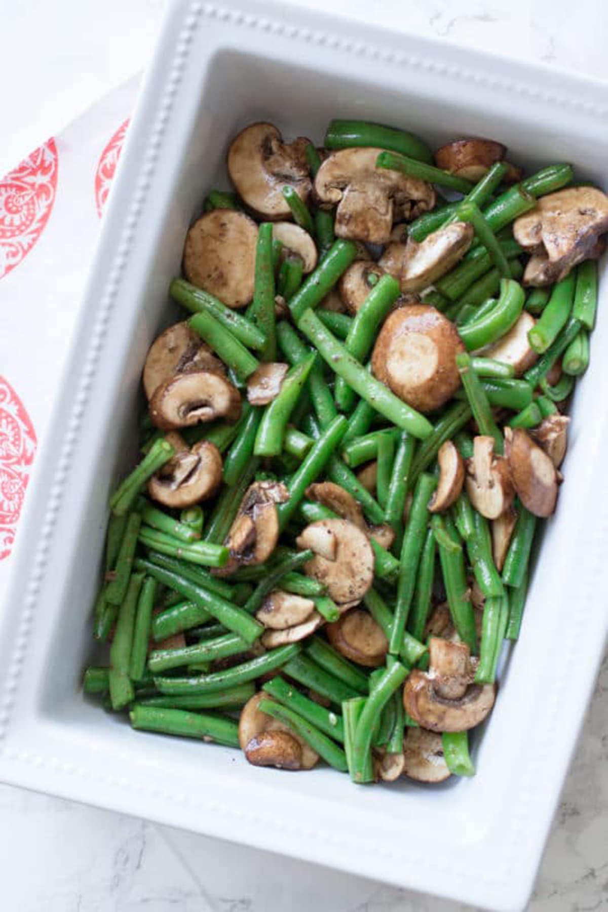 Seasoned green beans and mushrooms in an oven baked dish. 