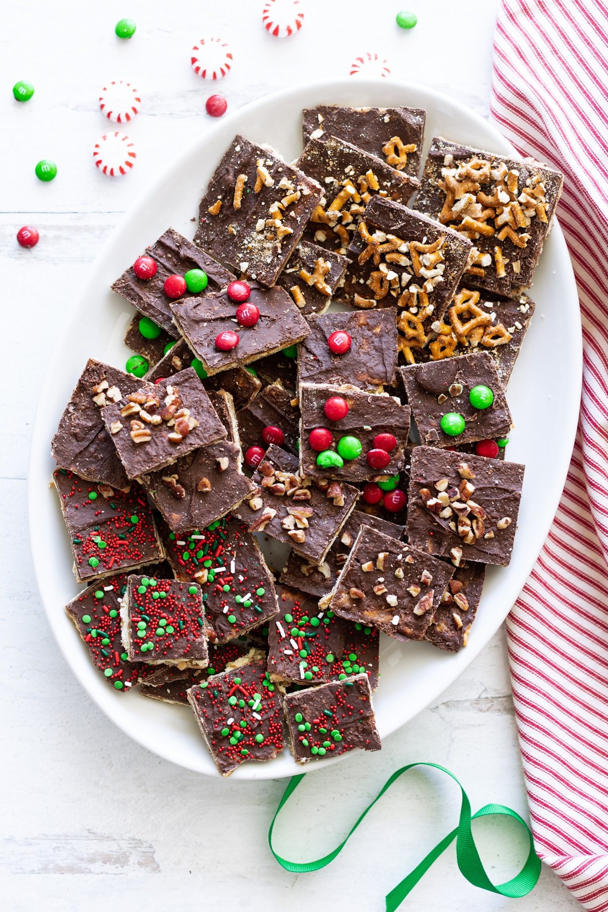 Platter filled with a variety of different candy topped Christmas crack. 