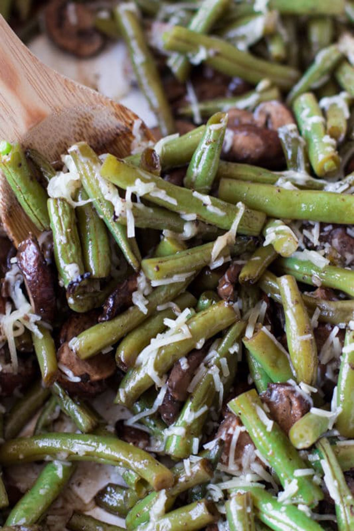 Spoonful of green beans topped with Parmesan cheese, 