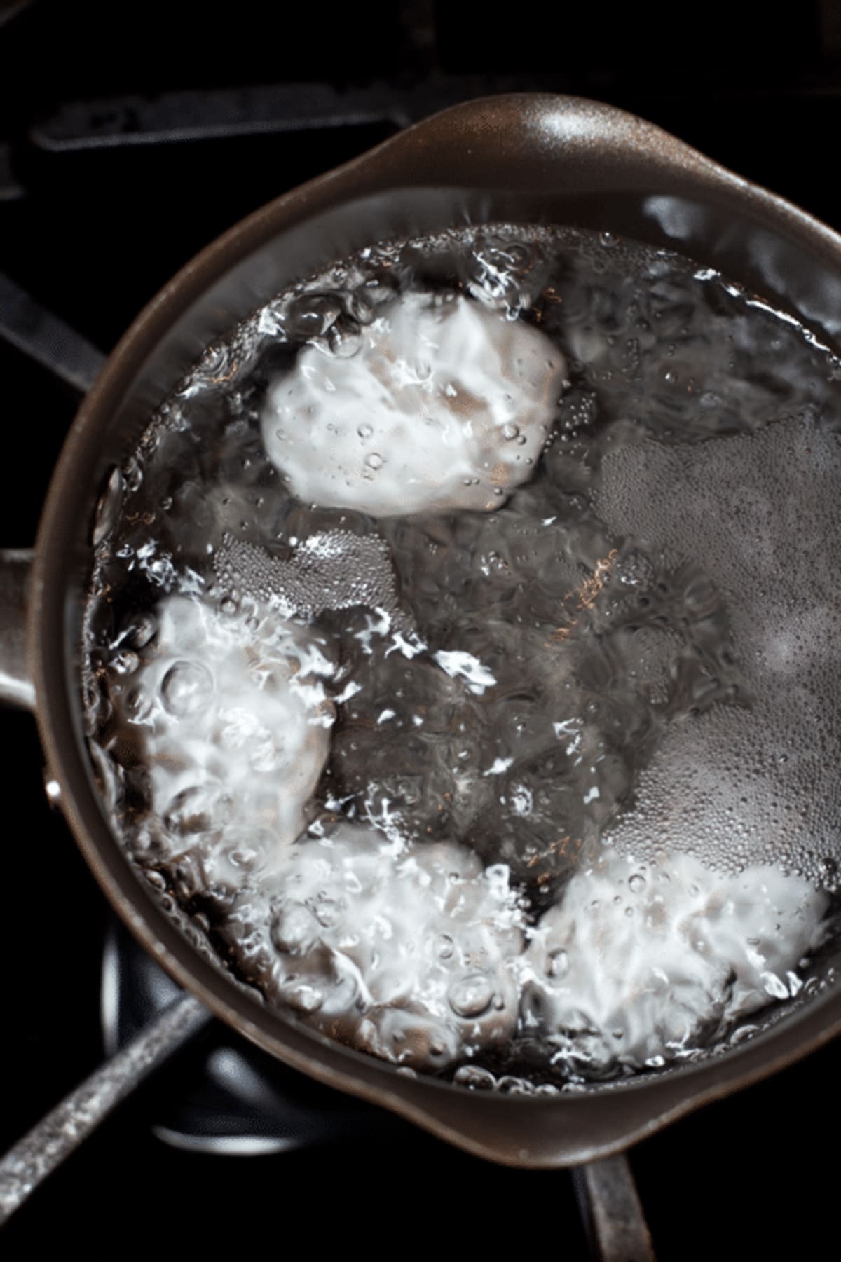 Eggs boiling in a pot of water. 