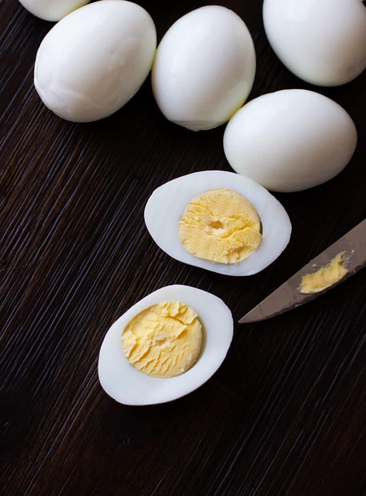 Eggs sliced lengthwise on a table.