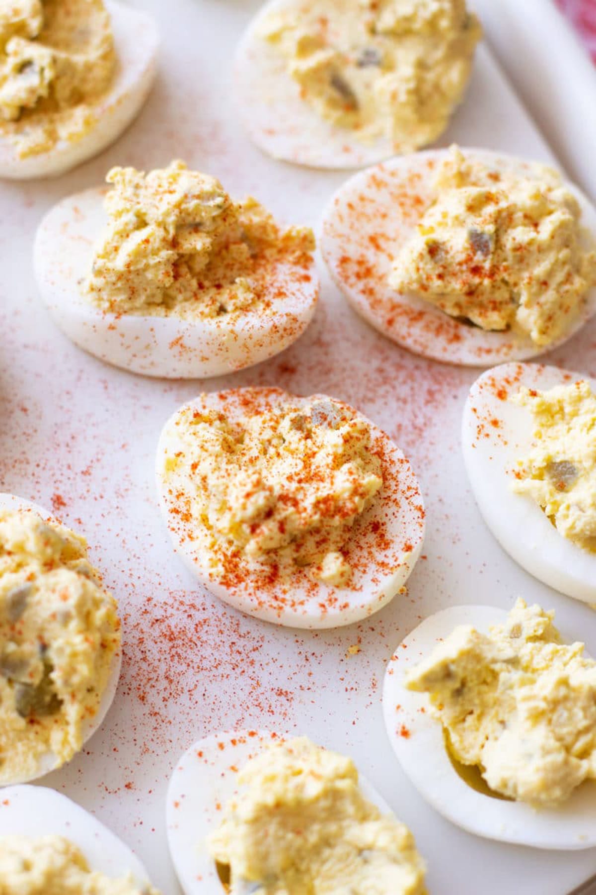 Close up of stuffed eggs topped with paprika.