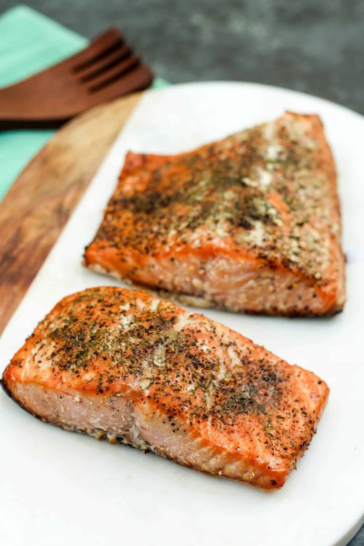 2 filets on a platter topped with seasoning. 