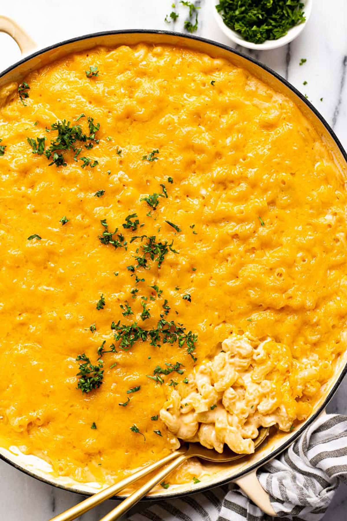 Spoonful of macaroni and cheese in a serving dish.