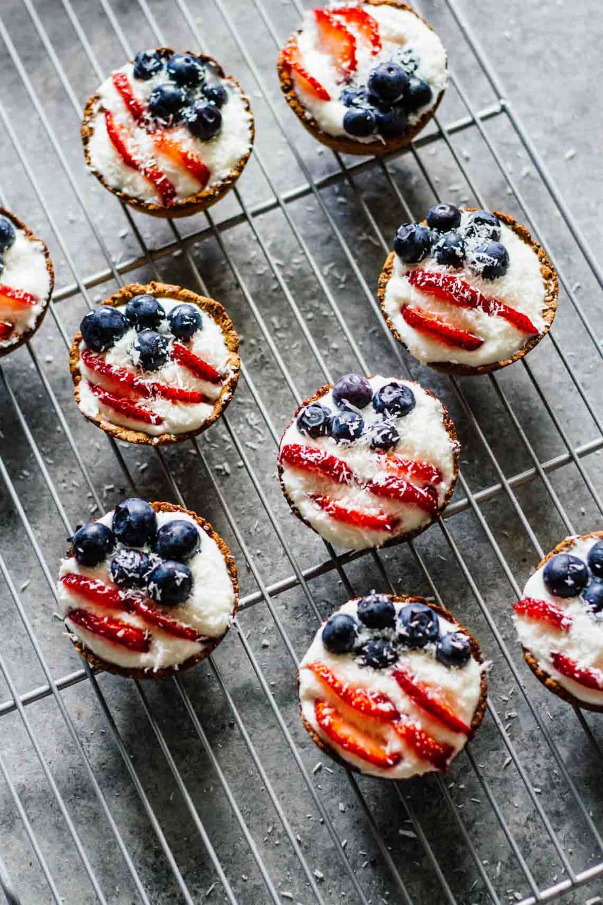 Mini patriotic tarts cooling on a wire rack. 