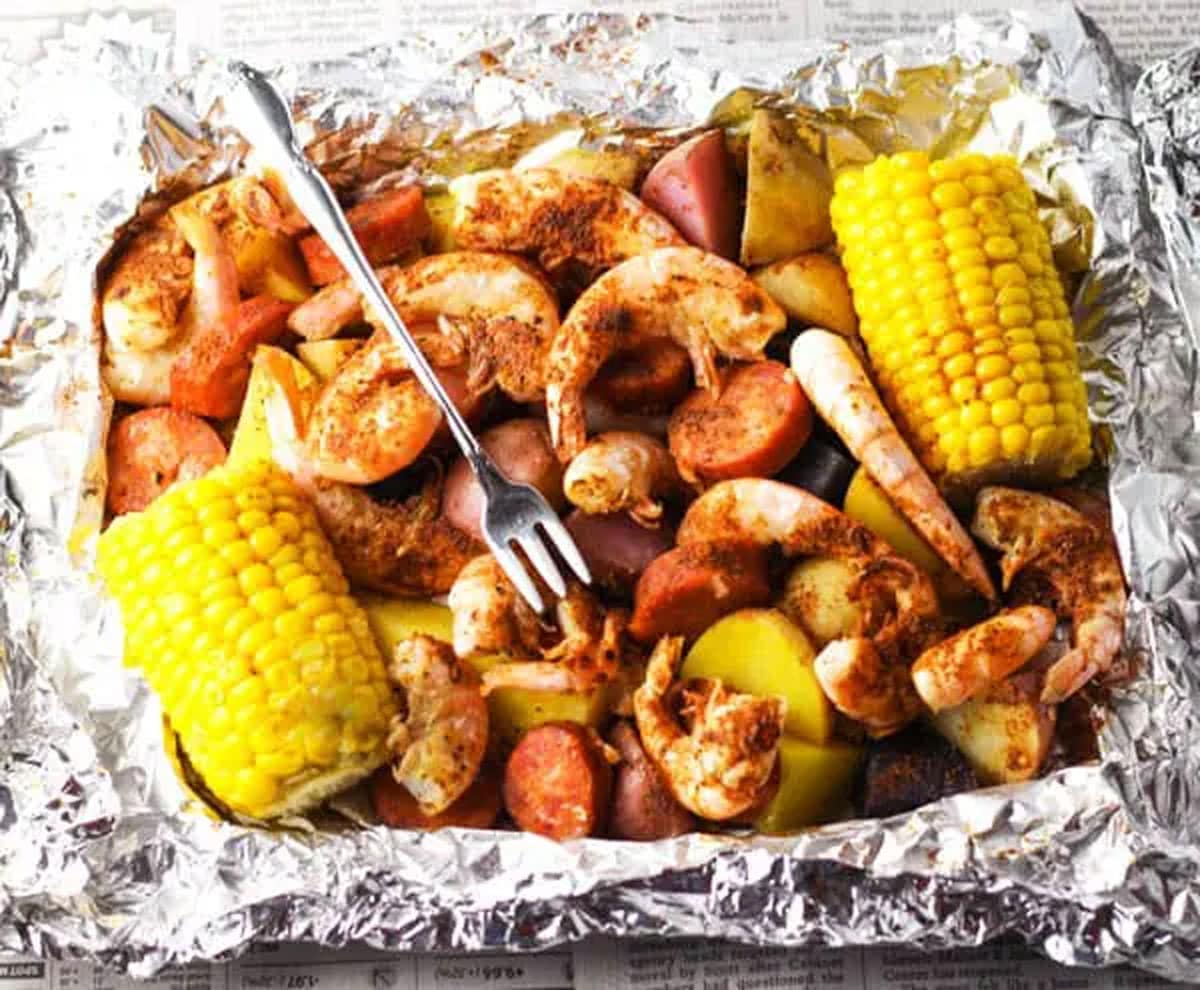 Aluminum foil filled with shrimp, sausage, and corn on the cob. 