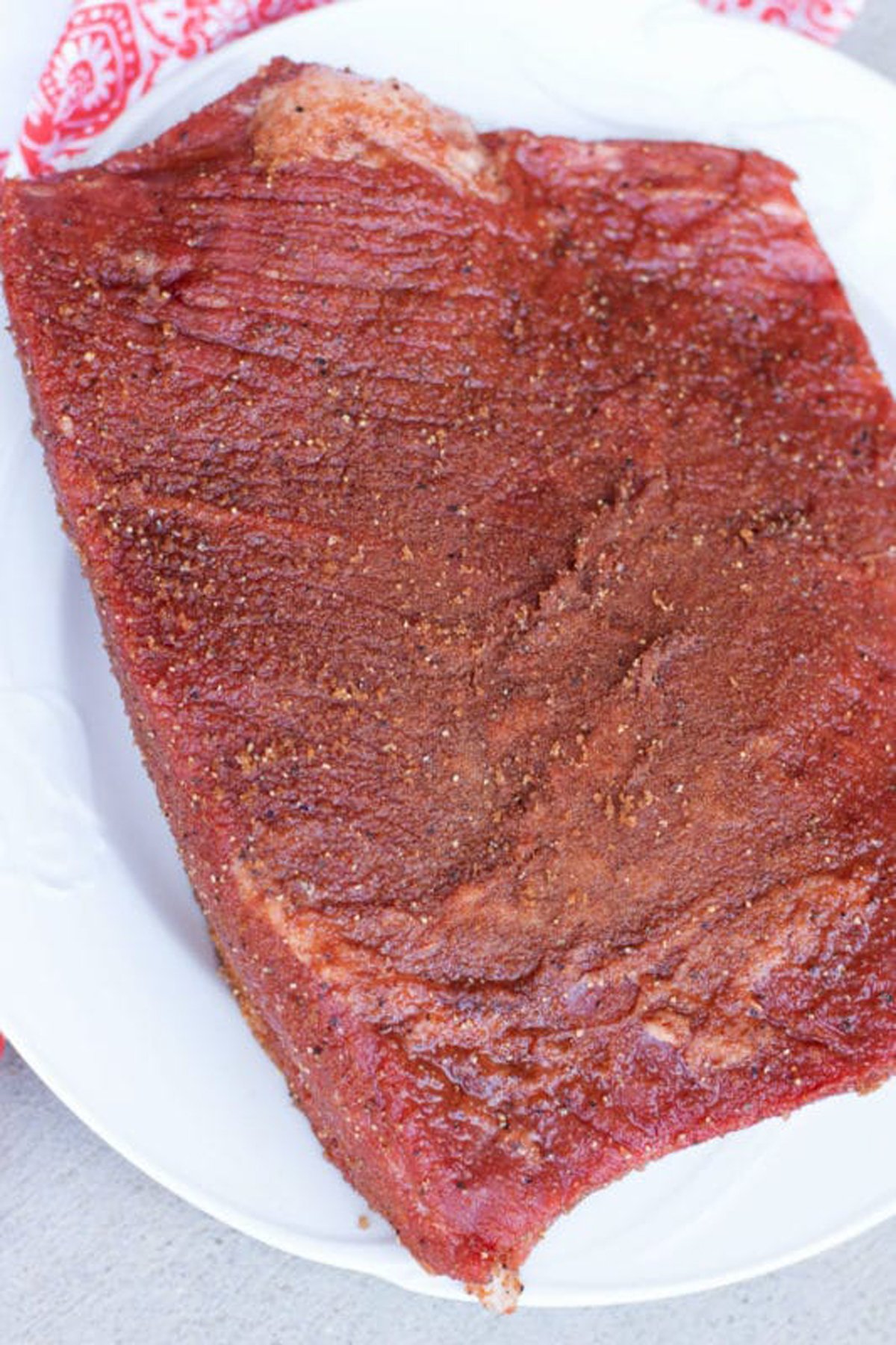 3 lbs of raw beef brisket covered in dry rub seasoing.