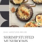 Six shrimp stuffed mushrooms on a cookie sheet being served.