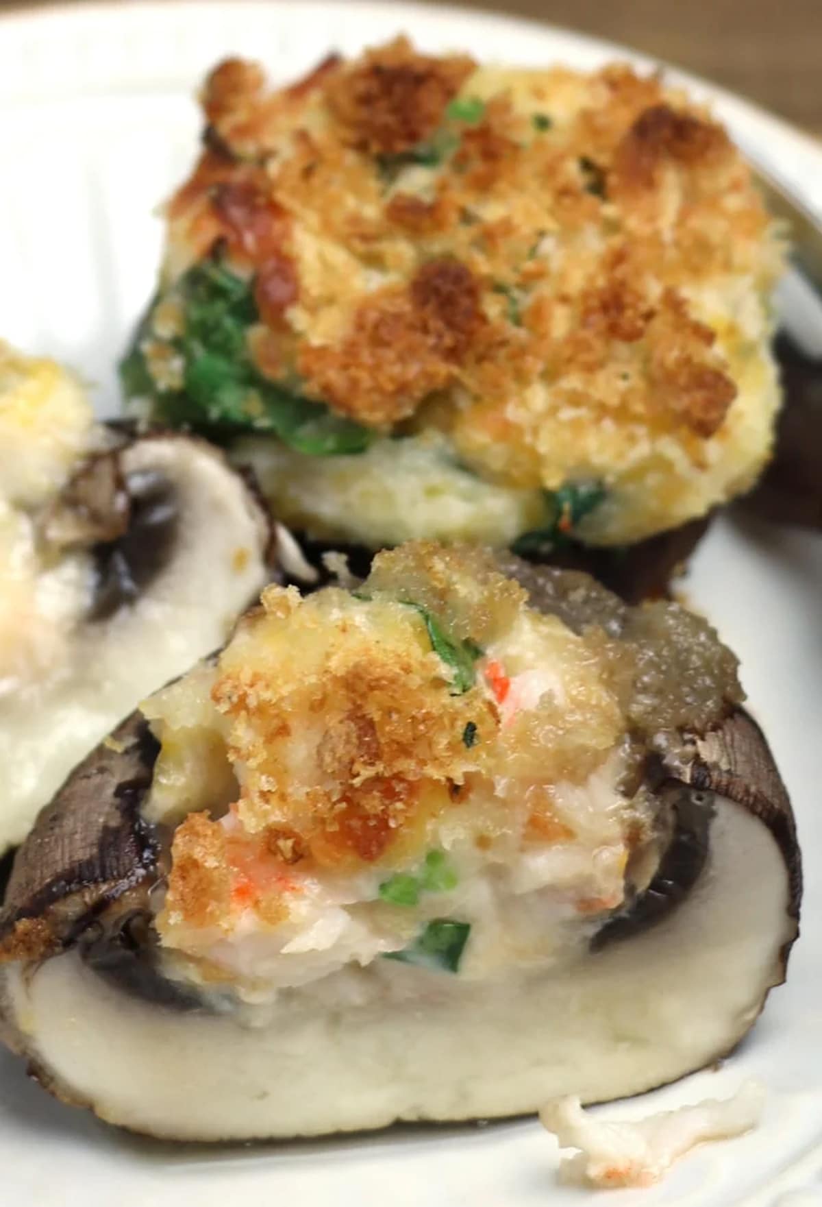 Sliced stuffed mushroom with shrimp and topped with breadcrumbs.
