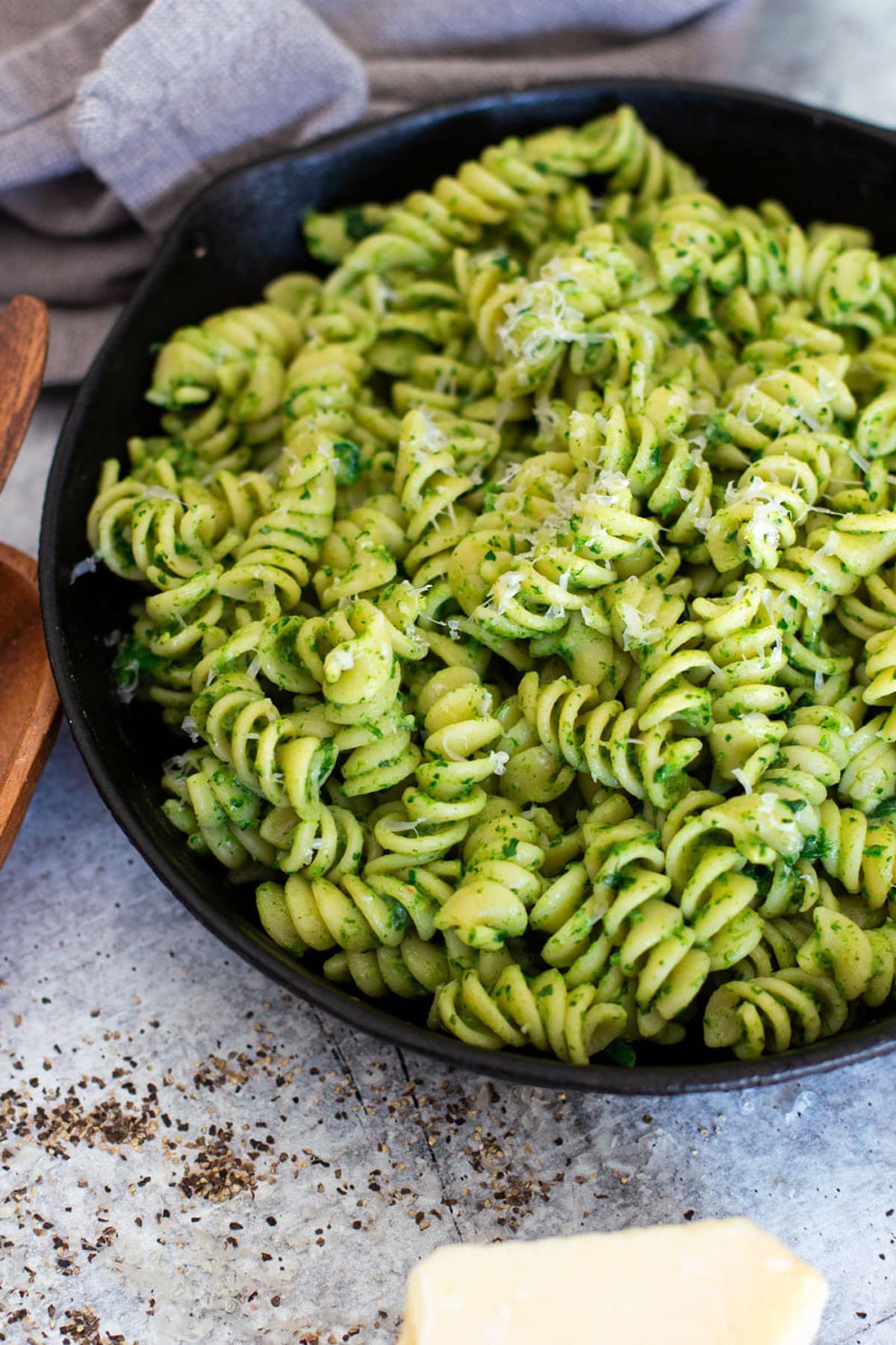 Close up of rotini pasta with avocado sauce being served.