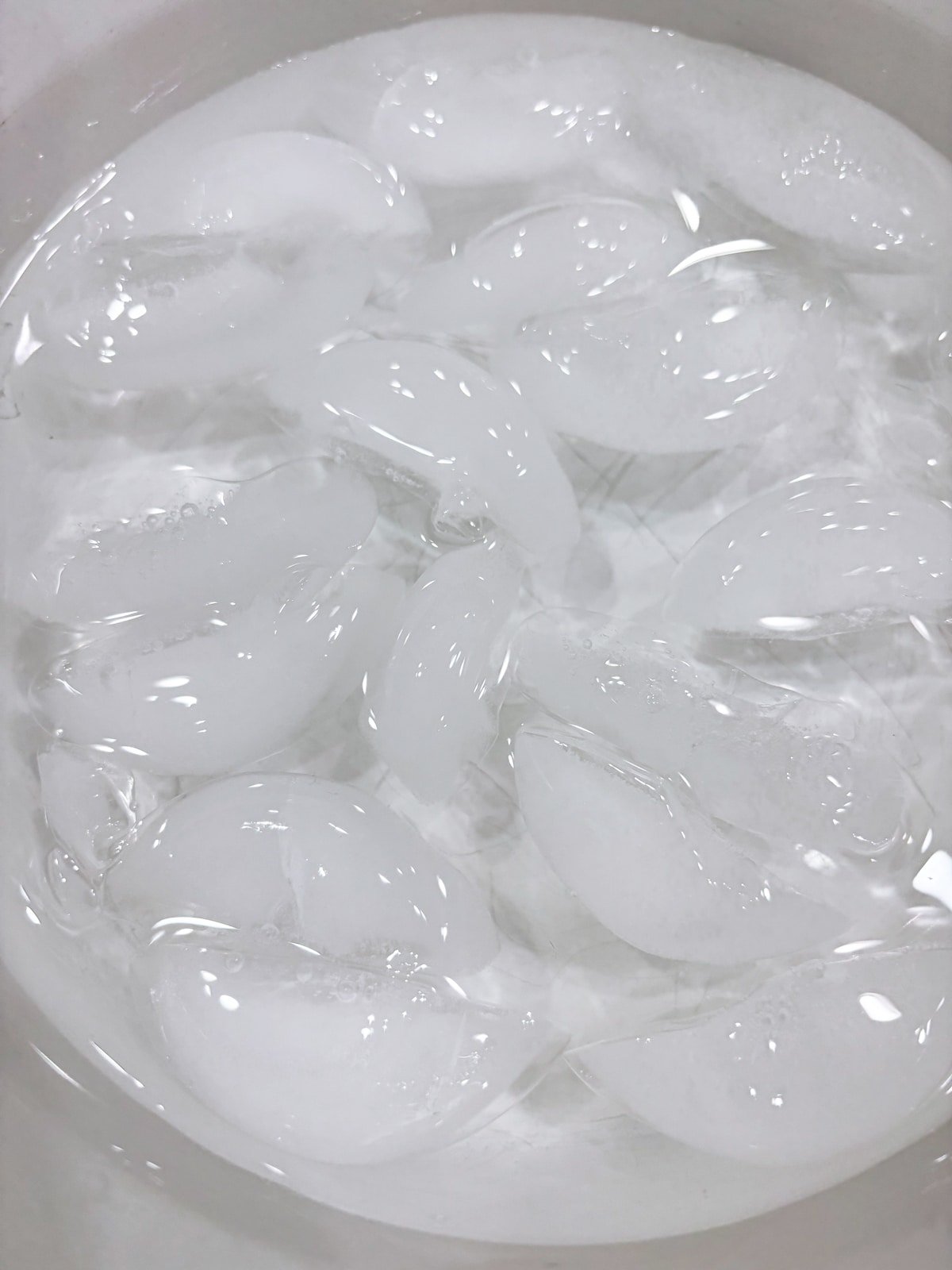 Bowl containing ice and water to do an ice bath for food. 