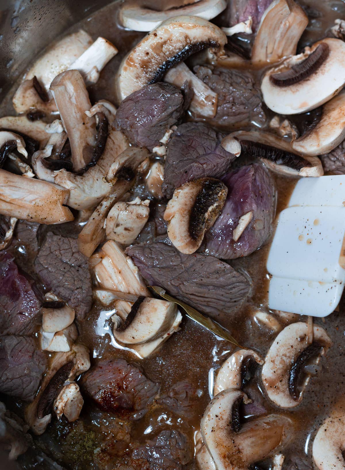 Beef stew meat, mushrooms, onions in an Instant Pot. 