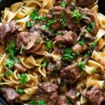 Close up of beef tips served over egg noodles.